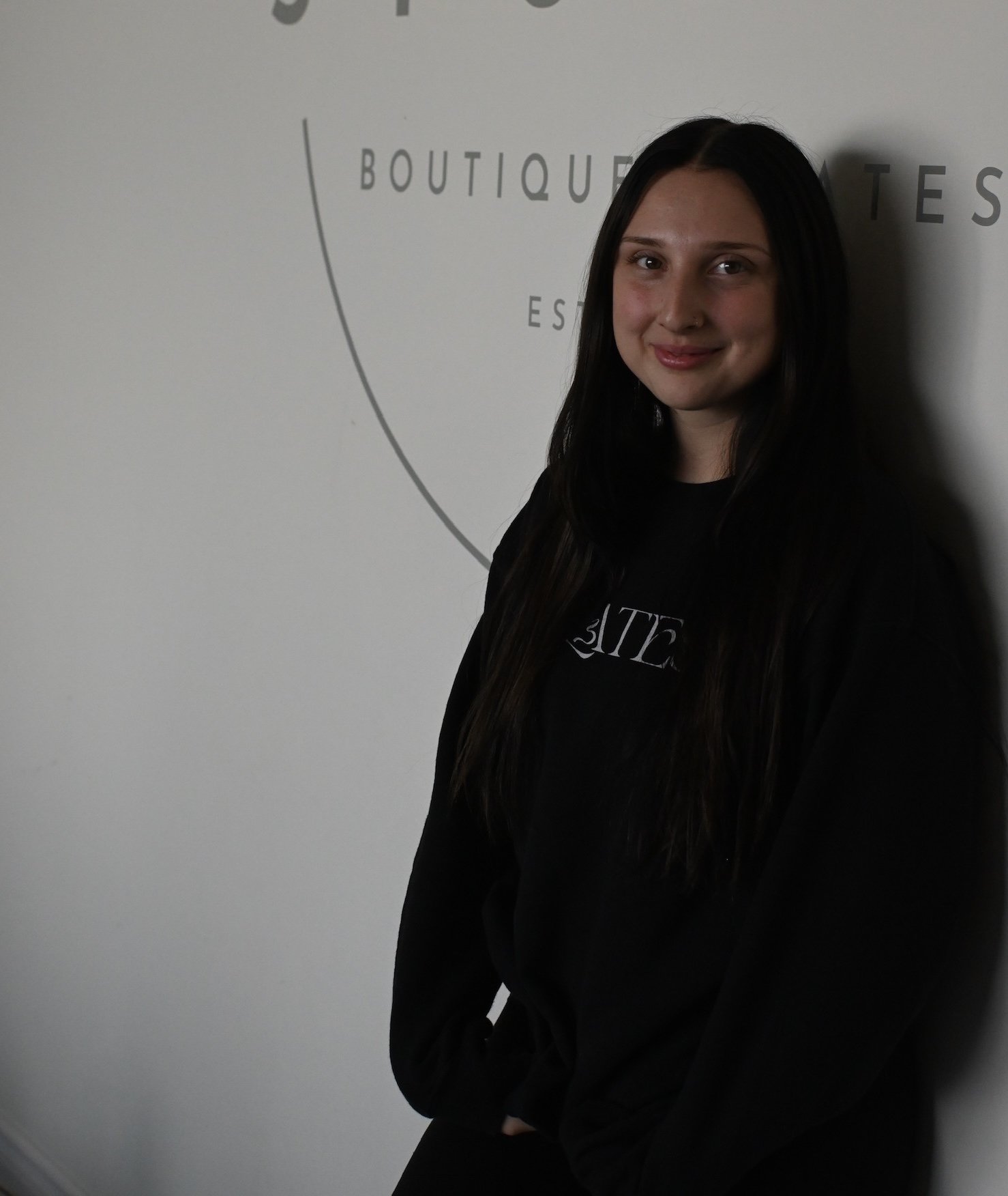 A young girl with dark hair smiling 