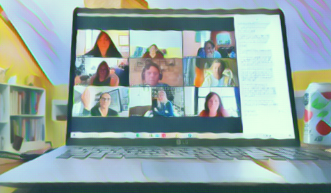 Evangeline Weiss Consulting | A laptop on a desk showing a virtual meeting with nine people on the screen.