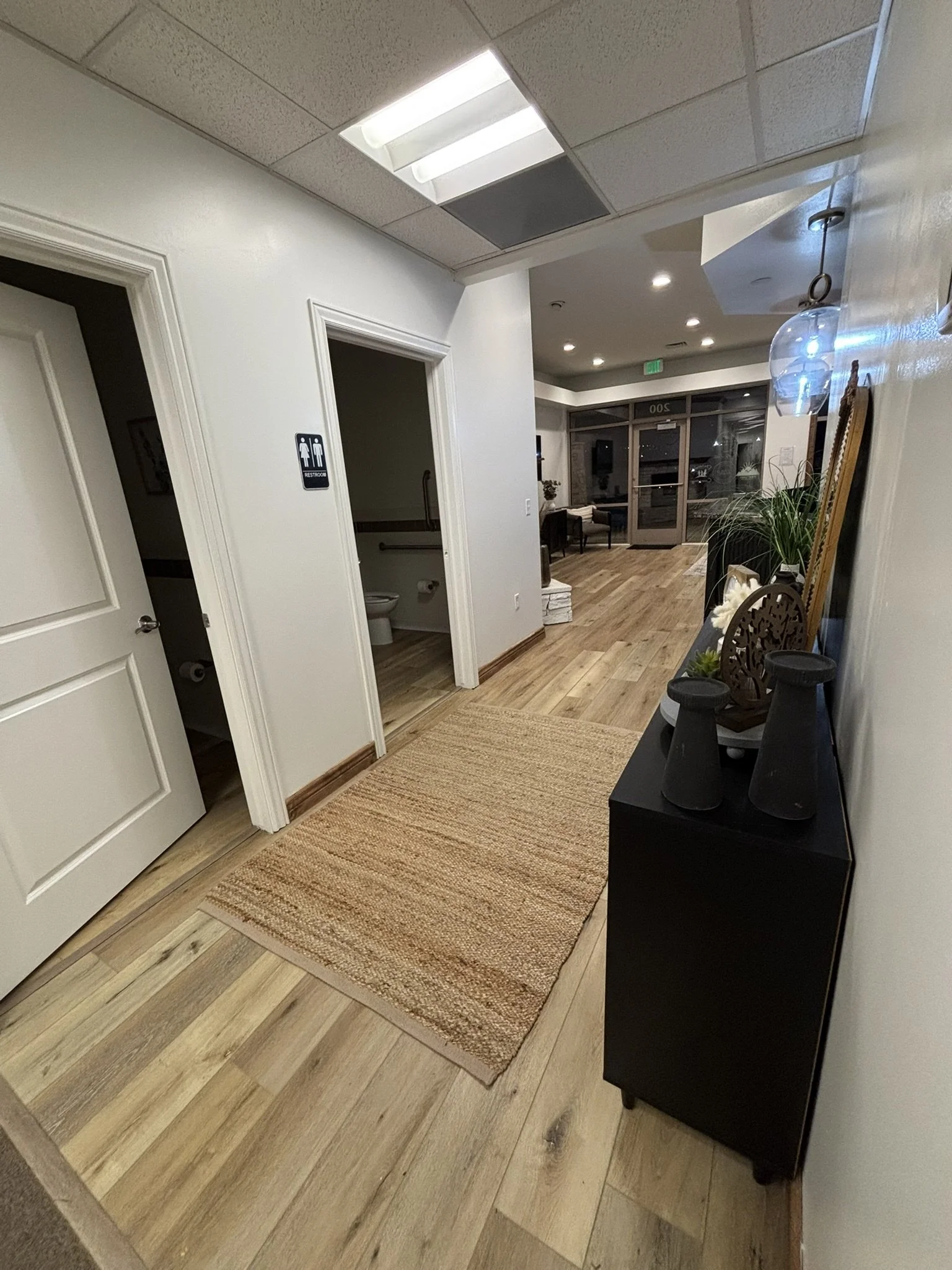 Quiet therapy office hallway with clean, accessible restrooms