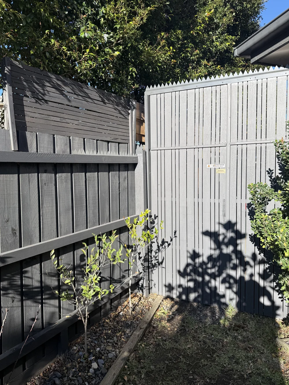 Anti-climb topper fitted above a side gate