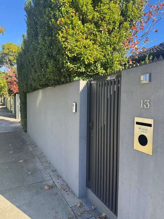 Anti-climb fence spikes screw-fixed to a fence capping
