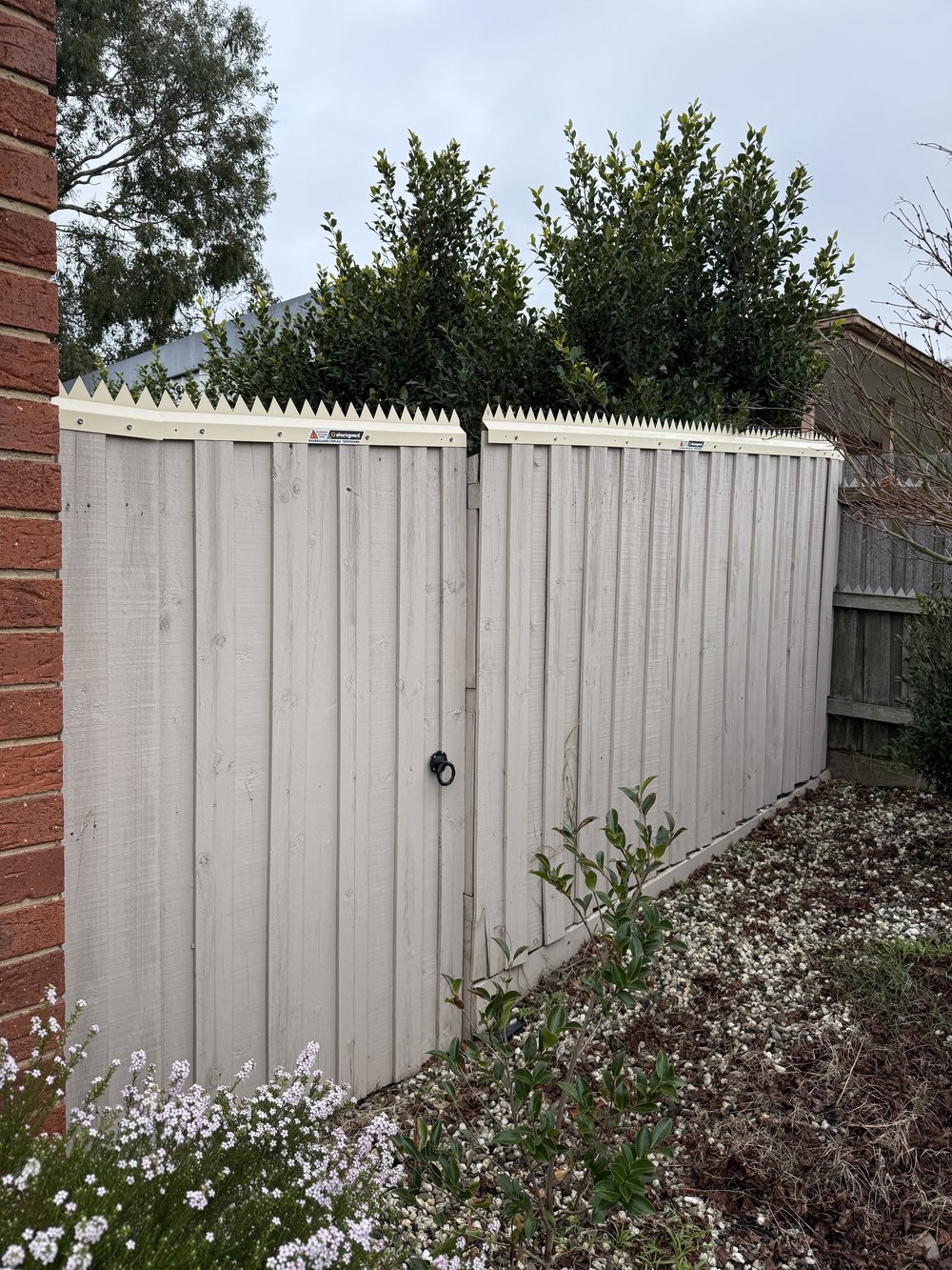 Completed anti-climb installation on a residential boundary