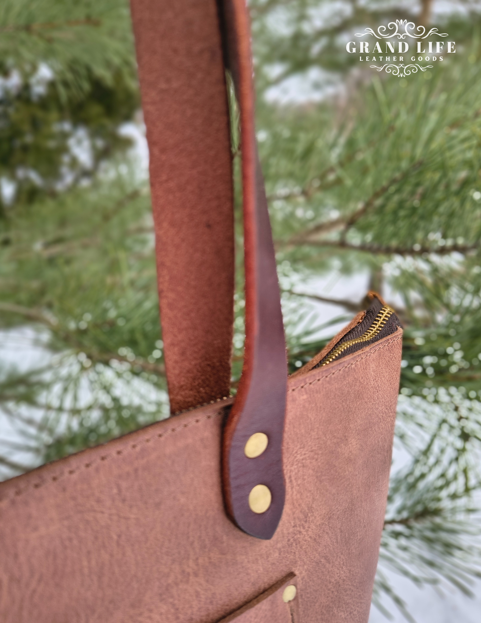 handcrafted leather tote bag with zipper top closure handle detail.png