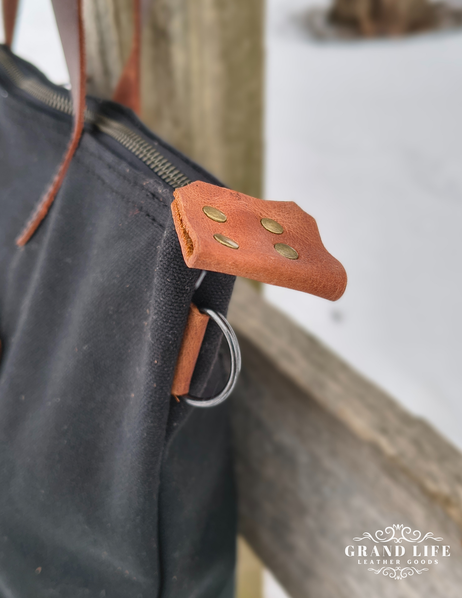 black canvas leather tote bag detail pull tab ring.png