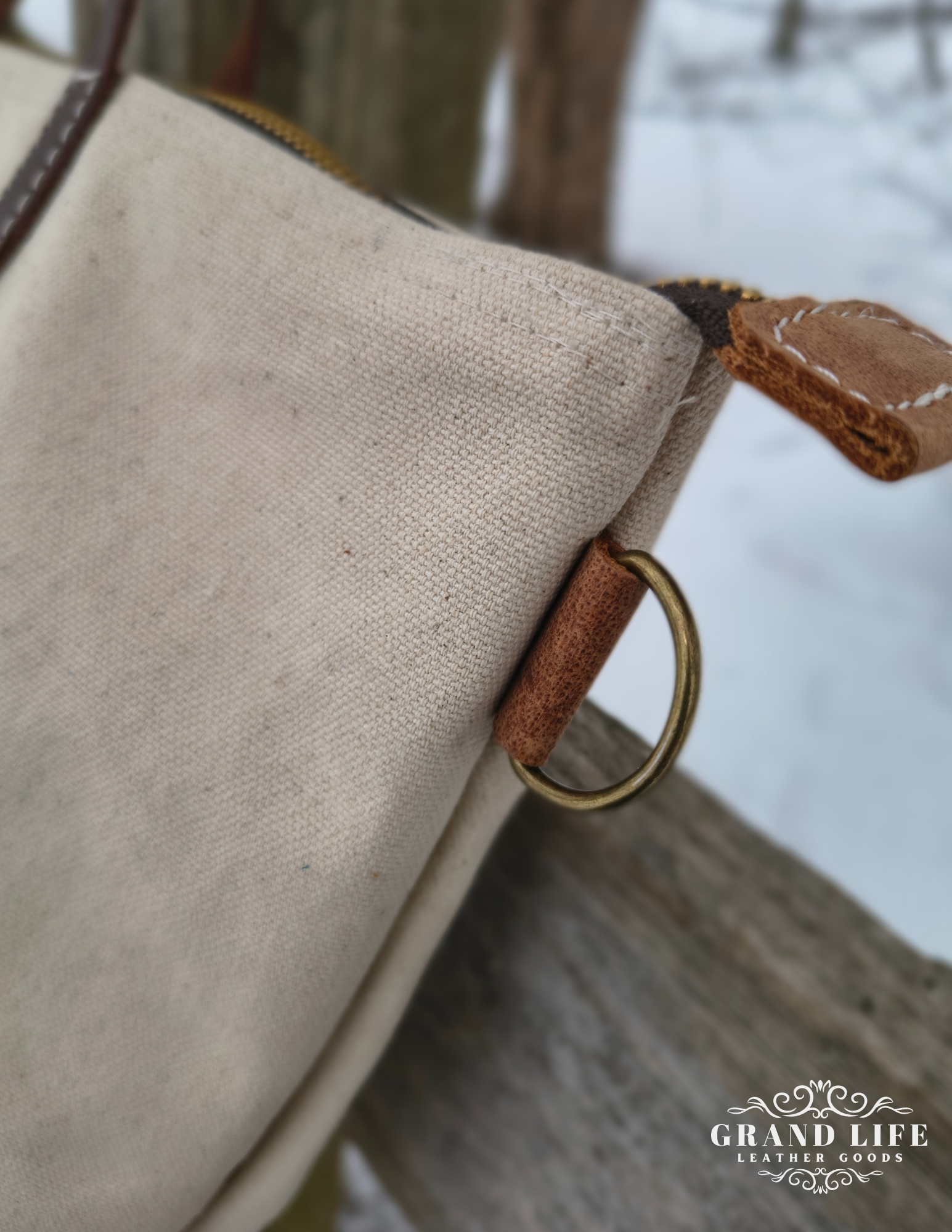 natural canvas leather tote bag detail pull tab ring.png