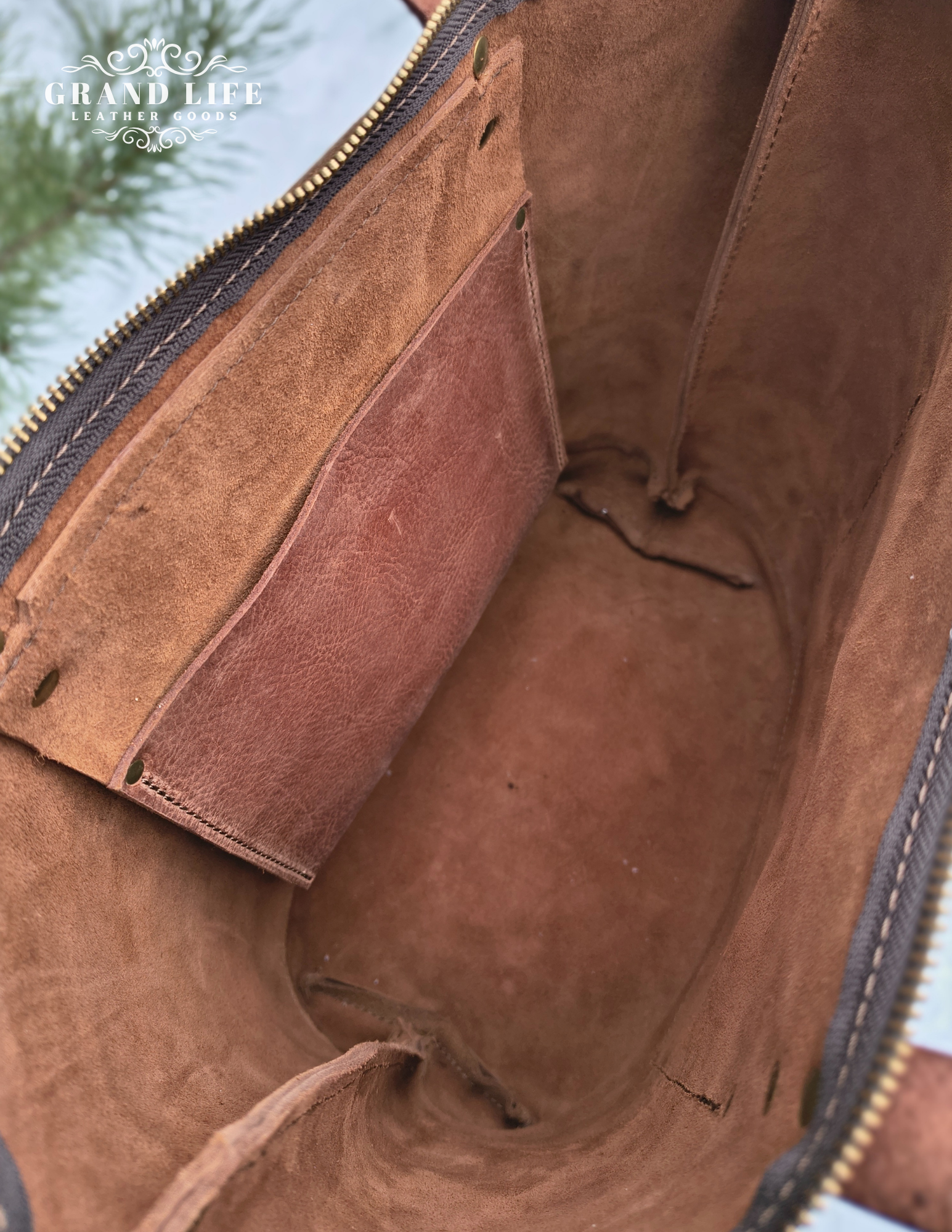 handcrafted leather tote bag with zipper top closure interior.png