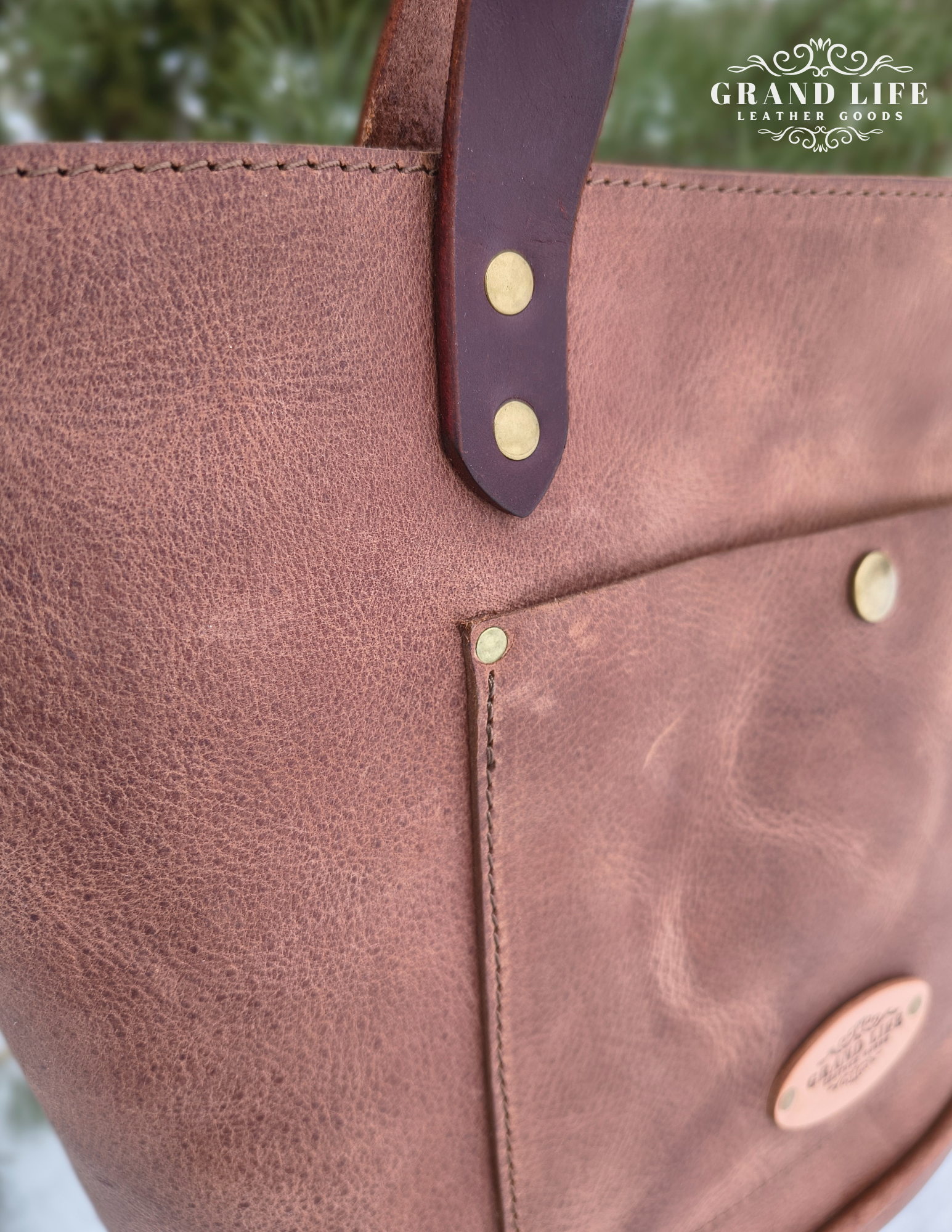 handcrafted leather tote bag with zipper top closure front detail.png