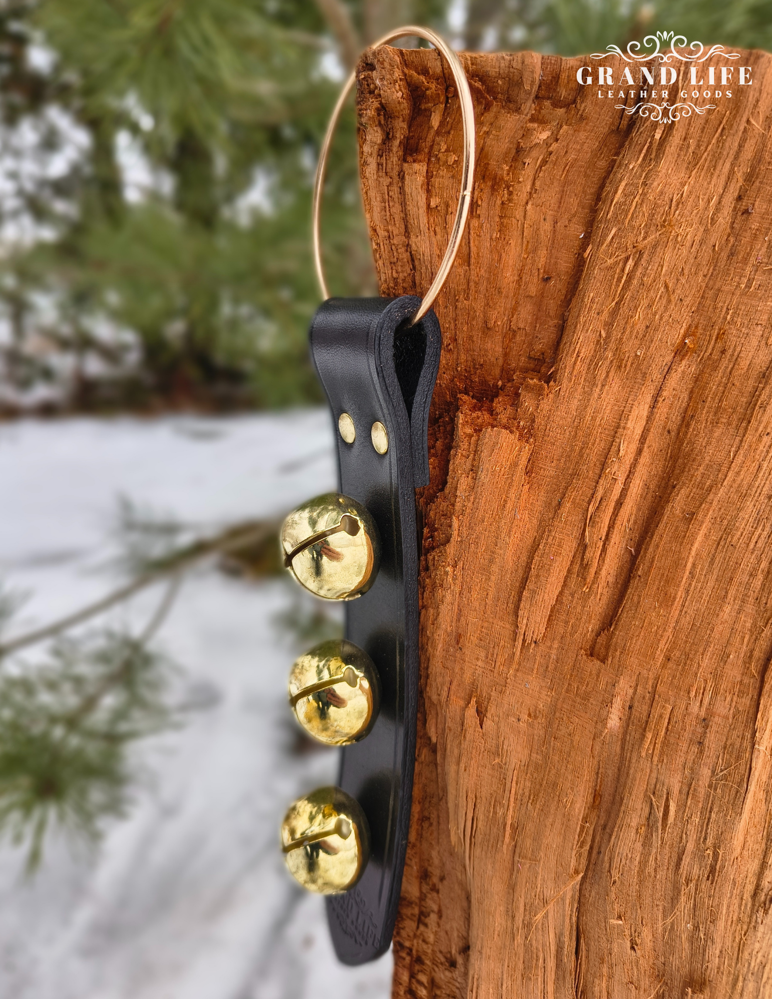 Handcrafted Leather Sleigh Bell Door Hanger - Three Bell brass on black strap detail.png