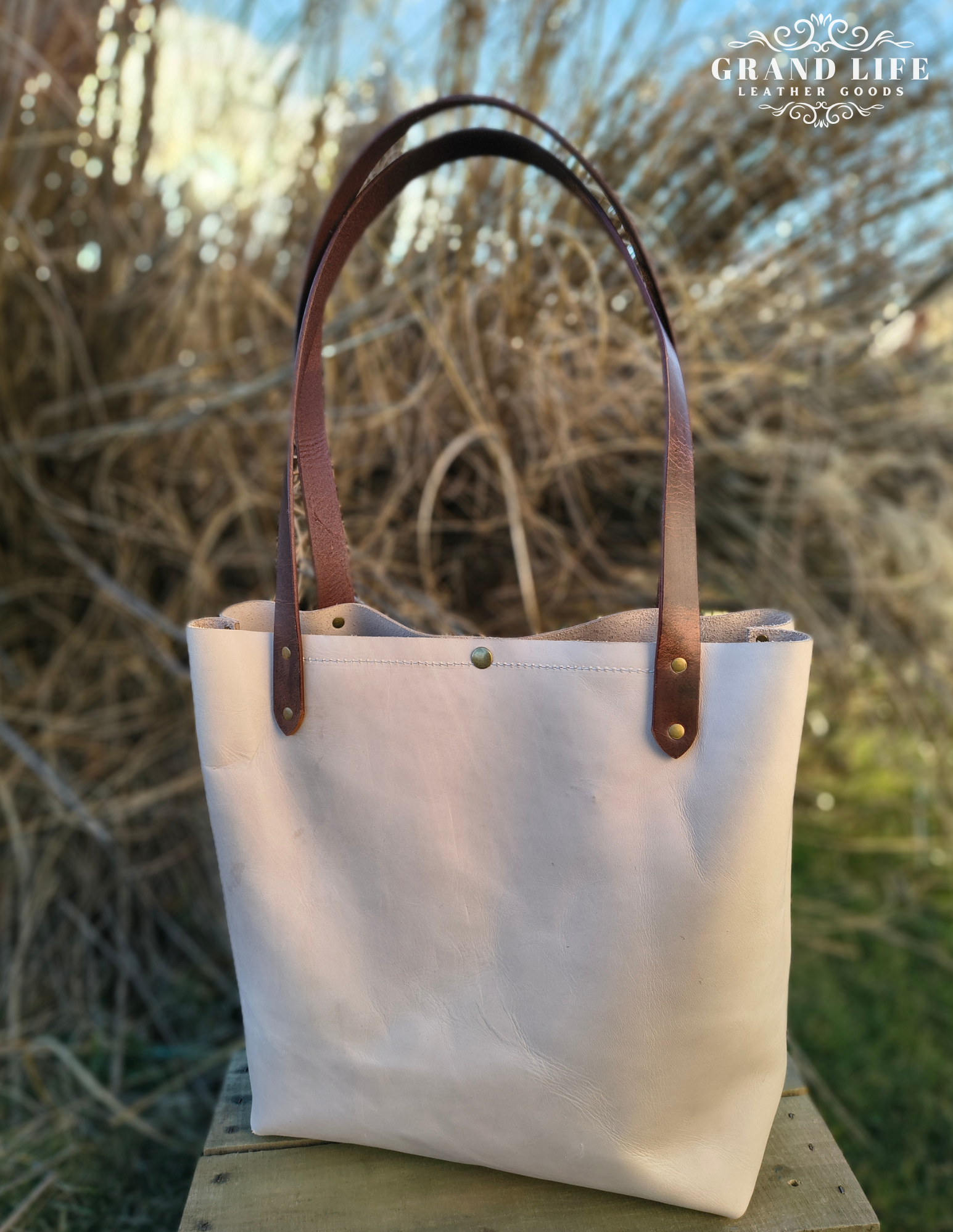 handcrafted leather carry all tote bag with snap top back.png