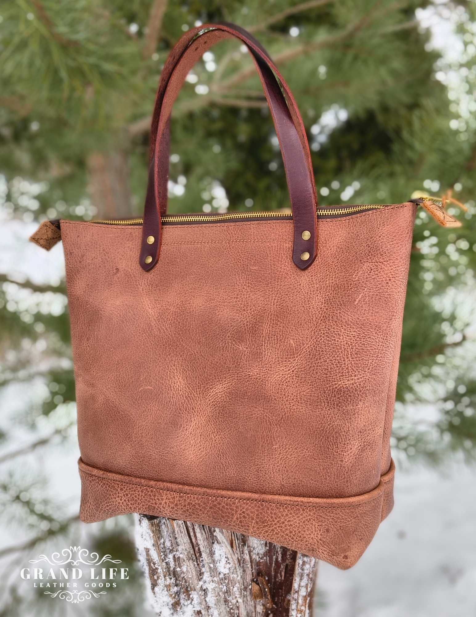 handcrafted leather tote bag with zipper top closure back.png