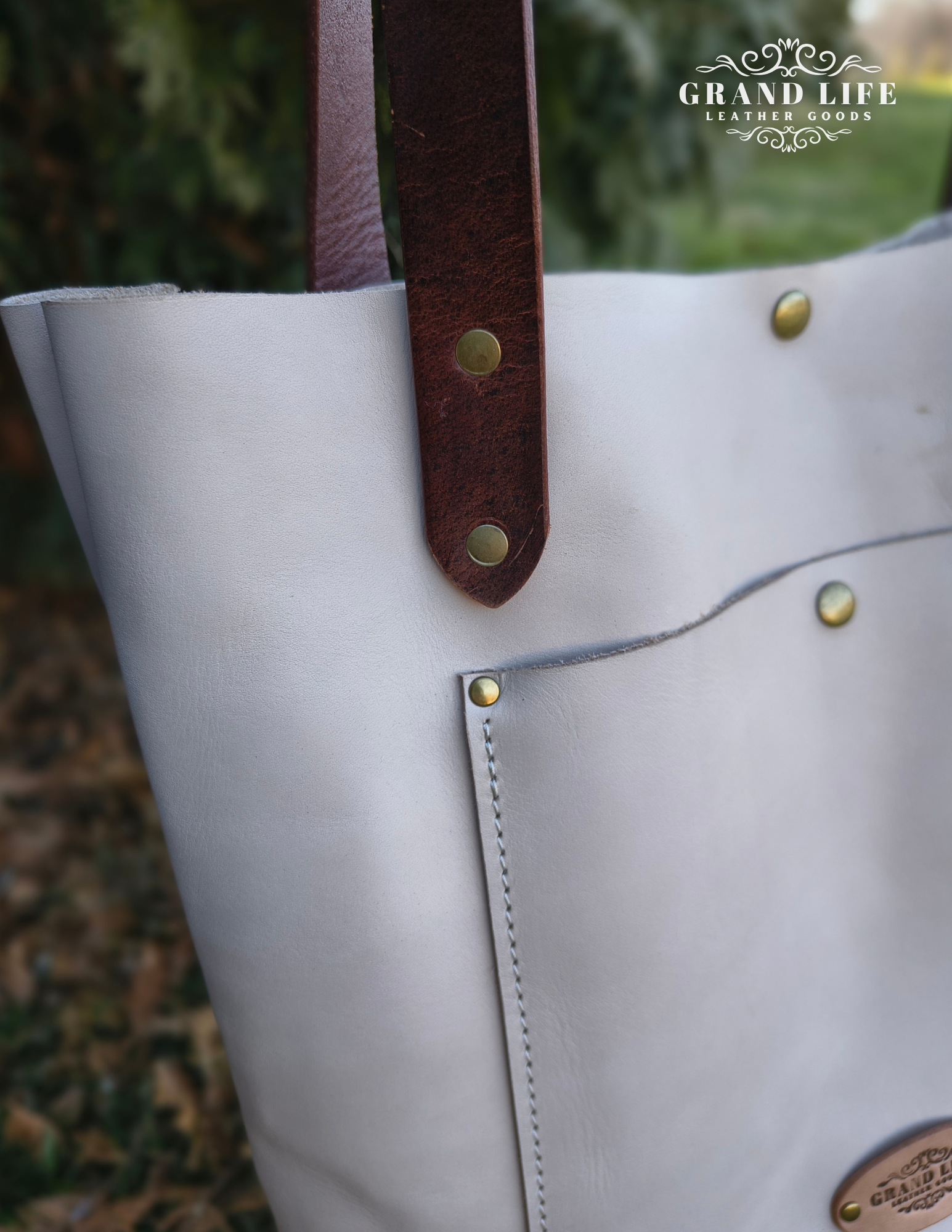 handcrafted leather carry all tote bag with snap top detail.png