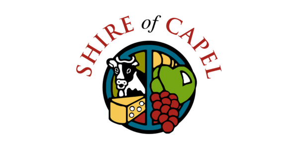 Seal of the Shire of Capel featuring a cow, cheese, grapes, and a vineyard.