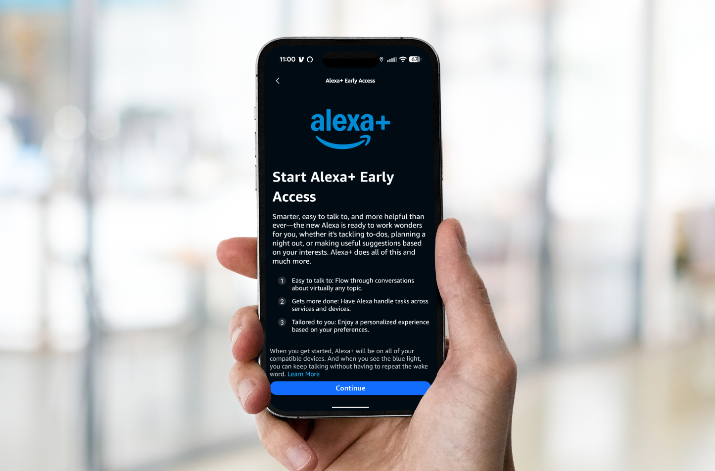 A hand holds a phone showing how customers can sign up for Alexa+ Early Access