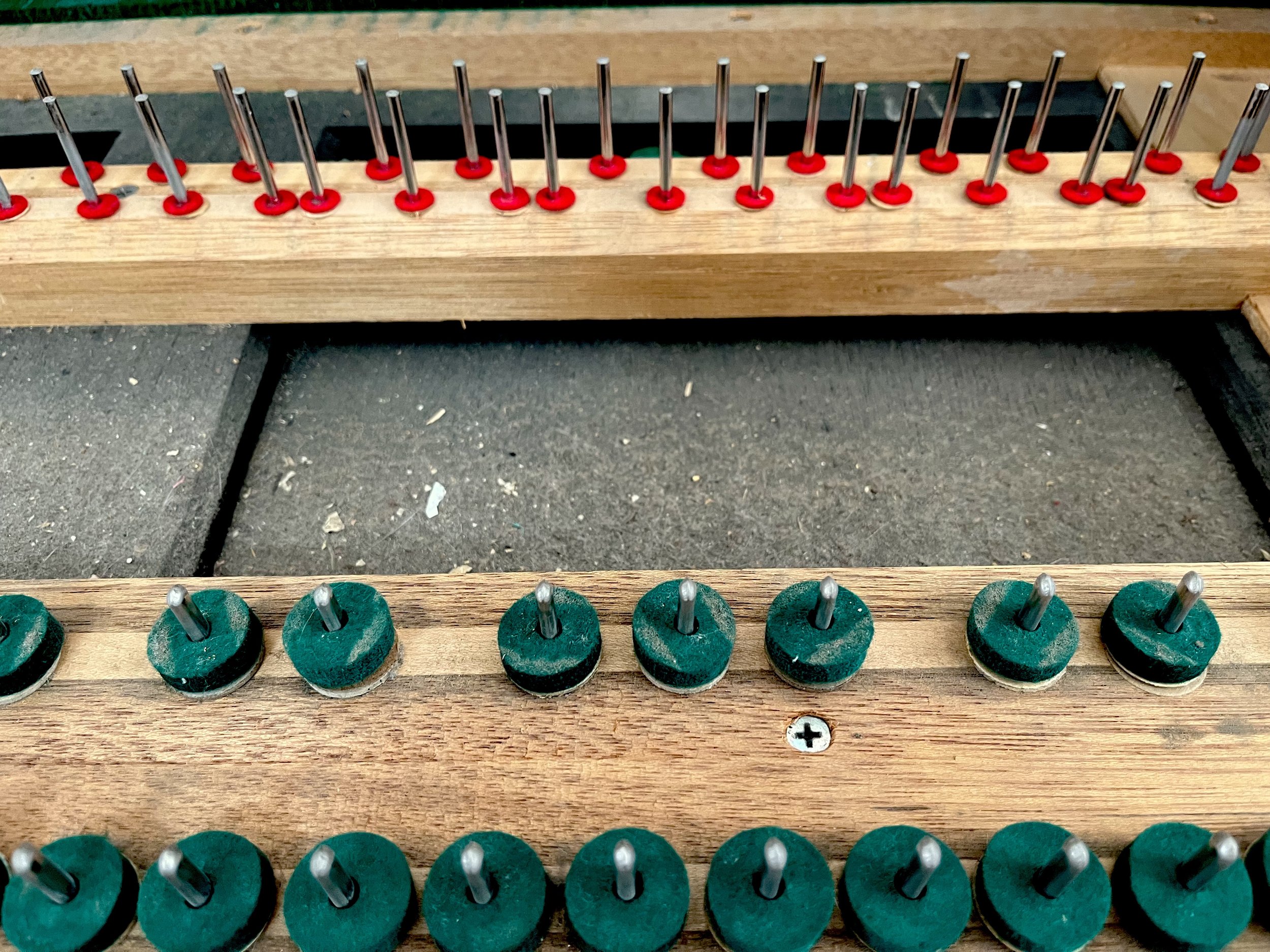 Close-up of a dusty and dirty upright piano key bed demonstrating what might be under your piano's keys.