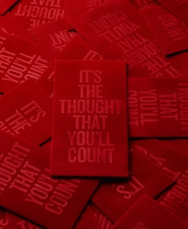Red cards with the motivational phrase "It's the thought that you'll count" printed on them, scattered around.