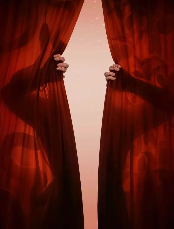 Hands opening red theater curtains, revealing a light pink background with small sparkles.
