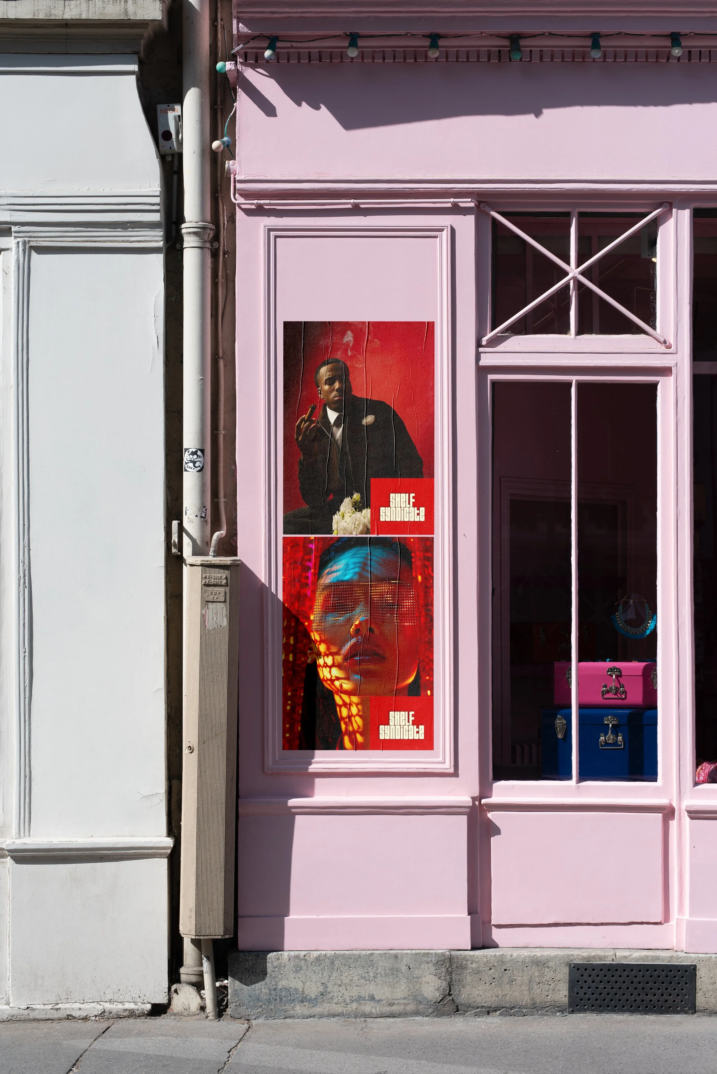 Pink storefront with posters of a man and a woman, with the words 'SHELF SUNDANCE' on each, displayed on the window.