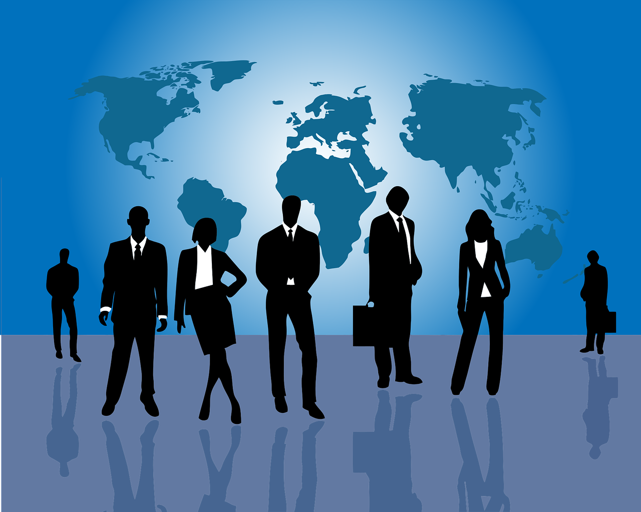 Silhouettes of businesspeople standing in front of a world map background