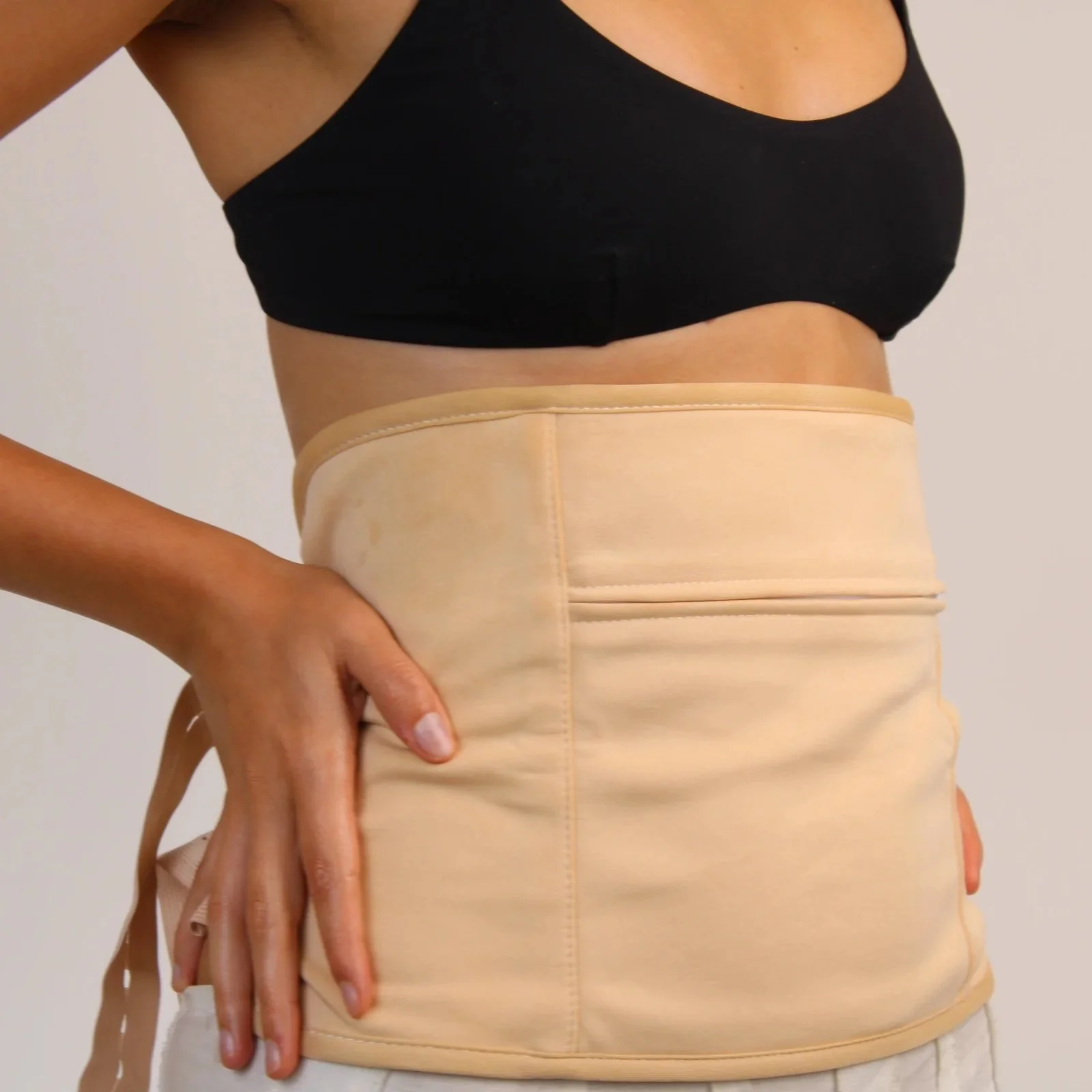 Person_wearing_a_honest_skincare_beige_waist_wrap_with_arm.jpeg