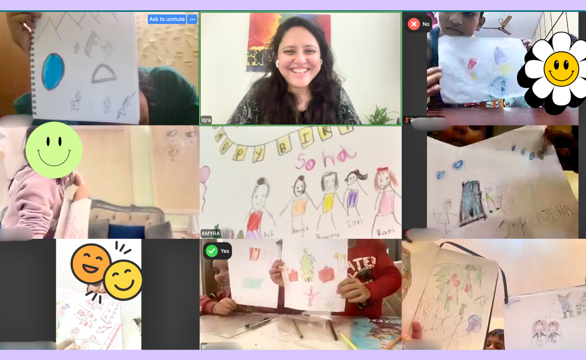 Screenshot of a virtual children’s art class with kids showing colorful drawings, some holding their artwork, and a smiling woman in the center.