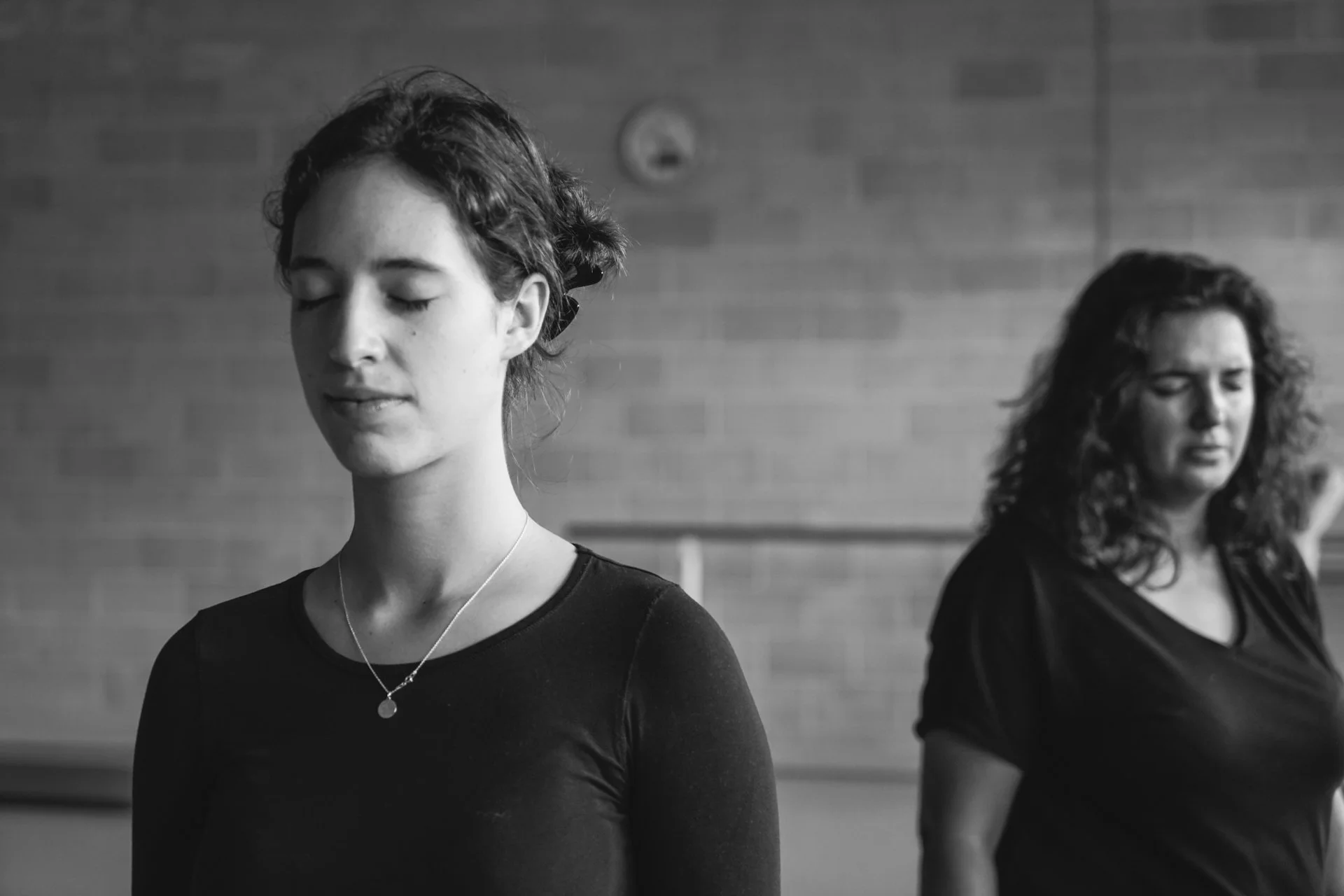 Two Perth French Theatre participants working on focus and presence during a rehearsal exercise.