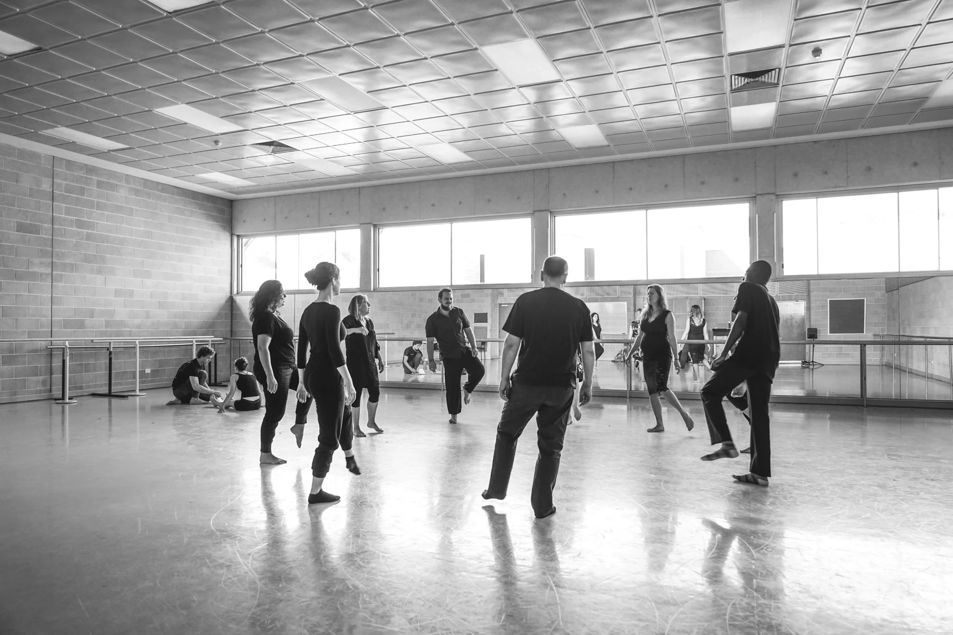 Perth French Theatre participants rehearsing movement together in a large studio.