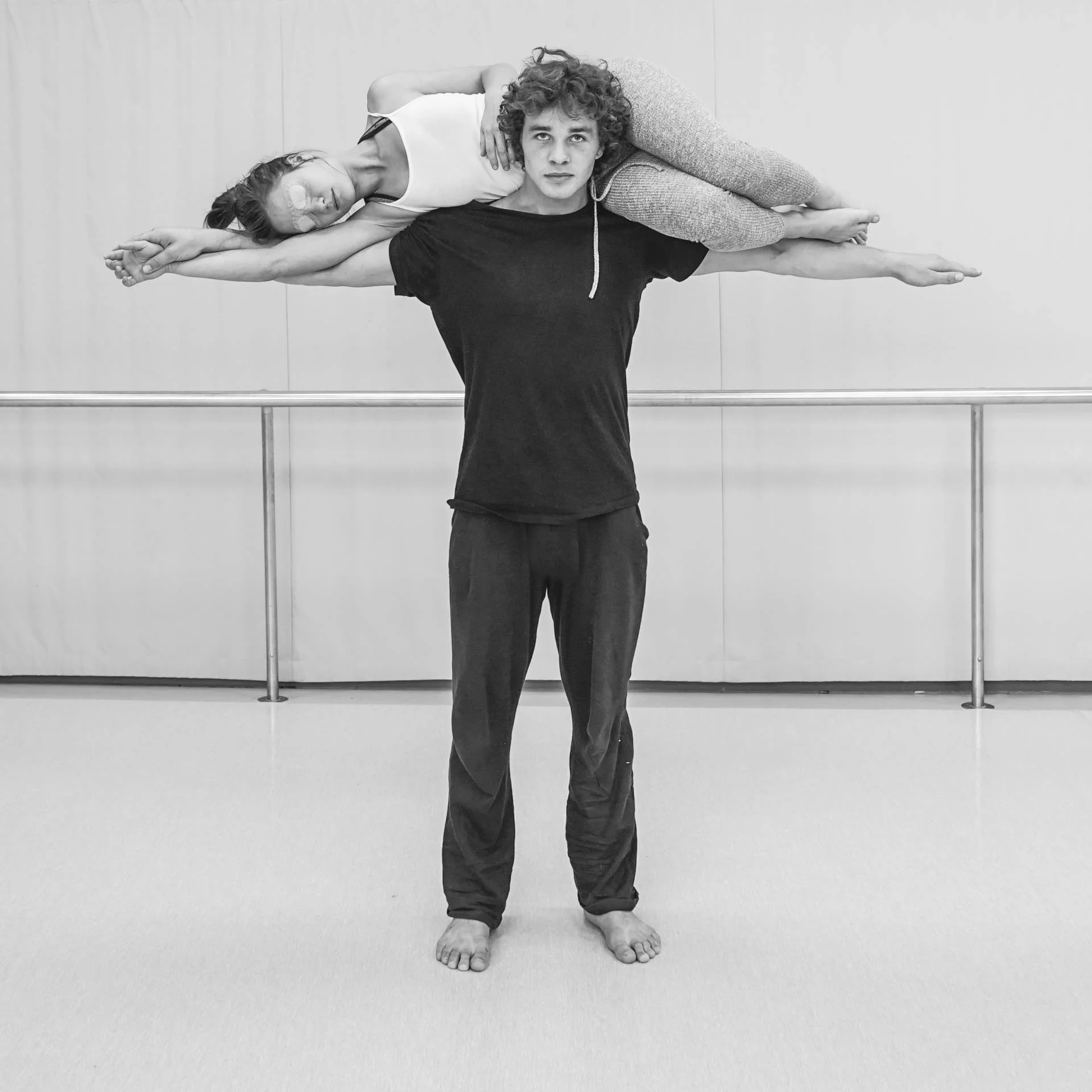 Perth French Theatre performers during a physical rehearsal for Tempête, with one performer carried across another’s shoulders.