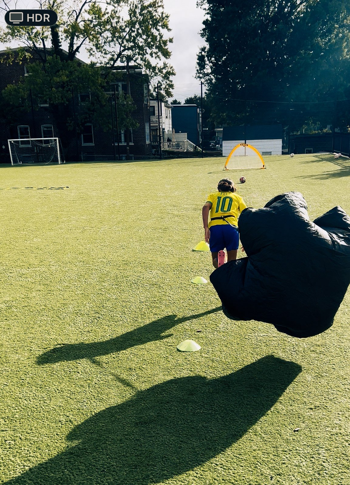 Soccer player doing speed work with a parachute_sports analytics and technical advisory