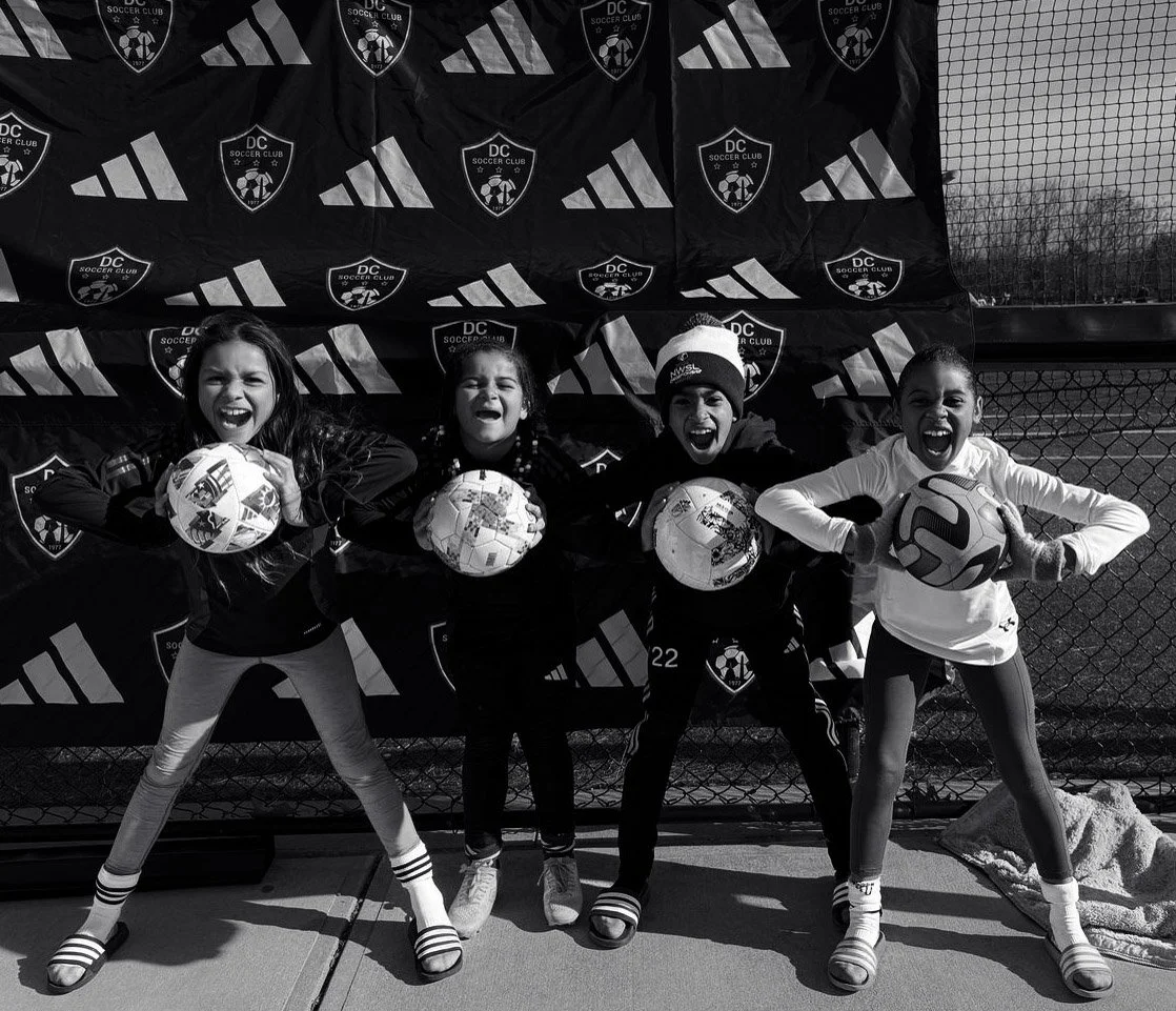 Socer players holding soccer balls_soccer training partners