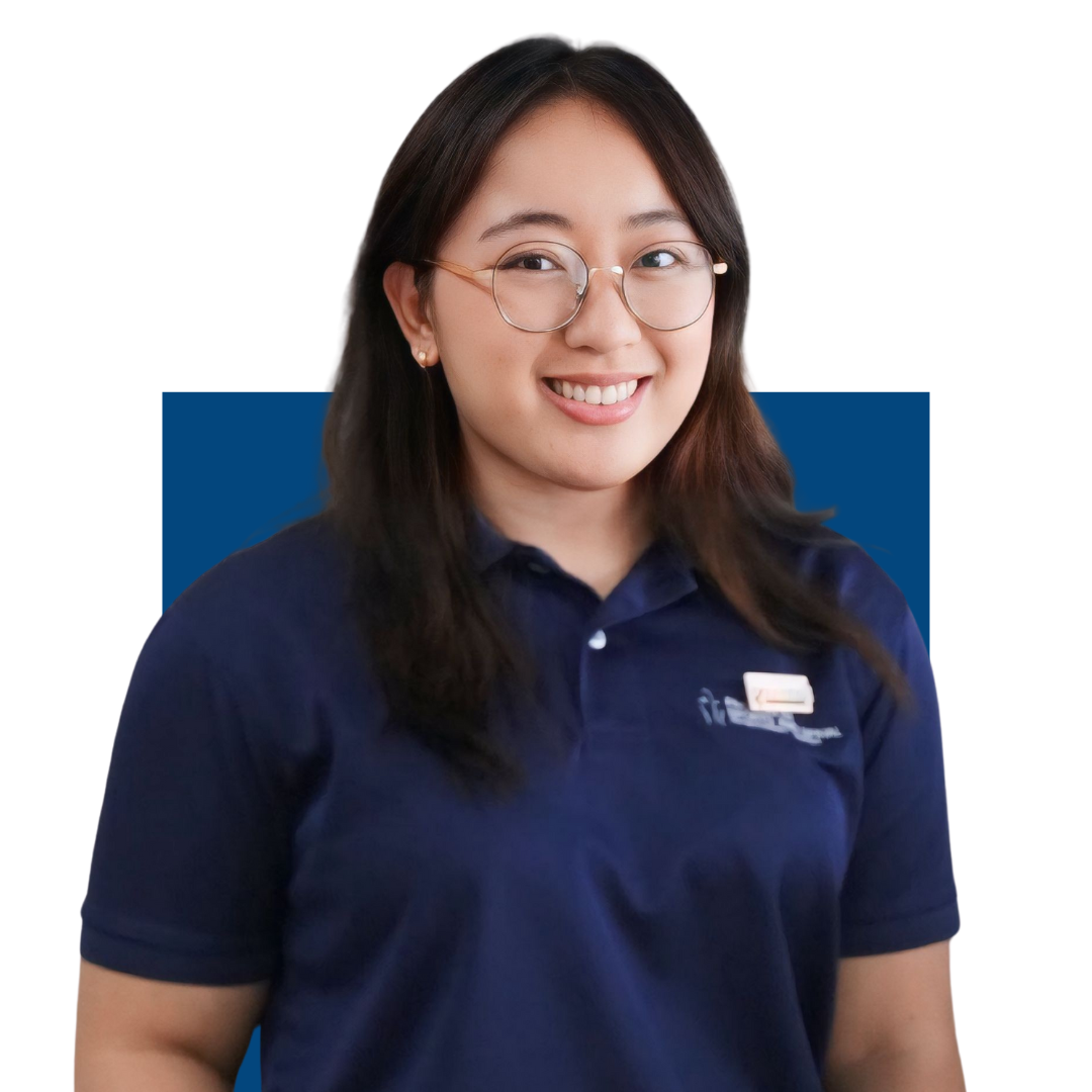 Smiling woman with glasses wearing a navy blue polo shirt with a badge.