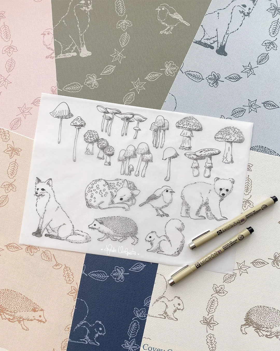 I drew these motifs in 2024, inspired by fall coming. I painted them and retraced them, and I made this sweet wooland pattern design while my son was playing around me (every mom can relate 😜 ). 

These whimsical nature sketches, mushrooms, woodland