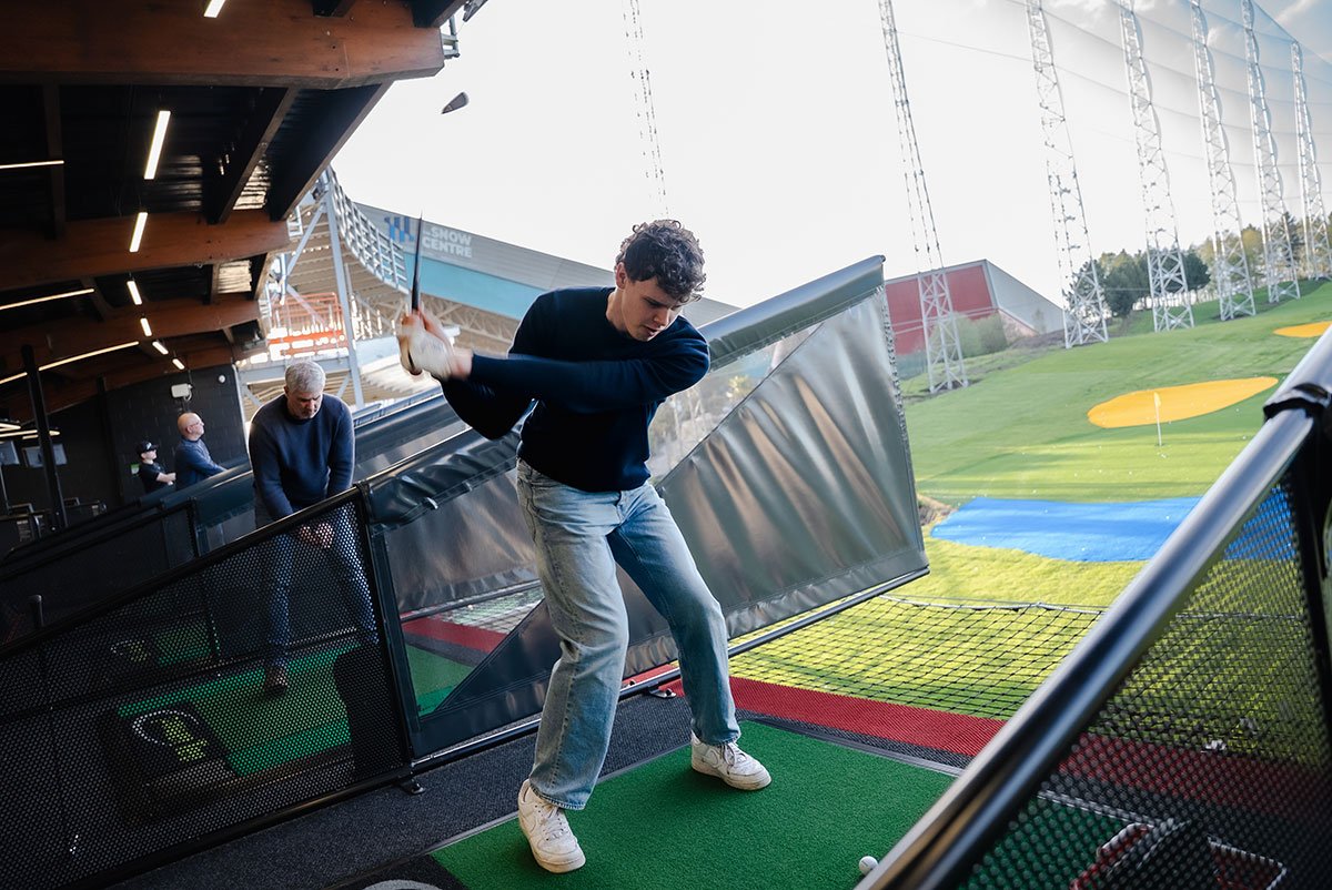 Male playing golf at driving range