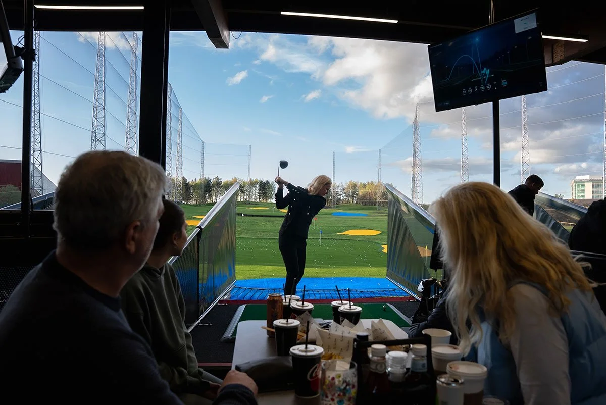 Family at driving range eating and drinking