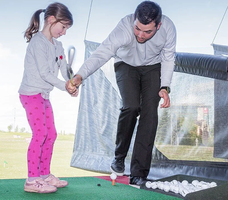 Young girl having a golf coaching session