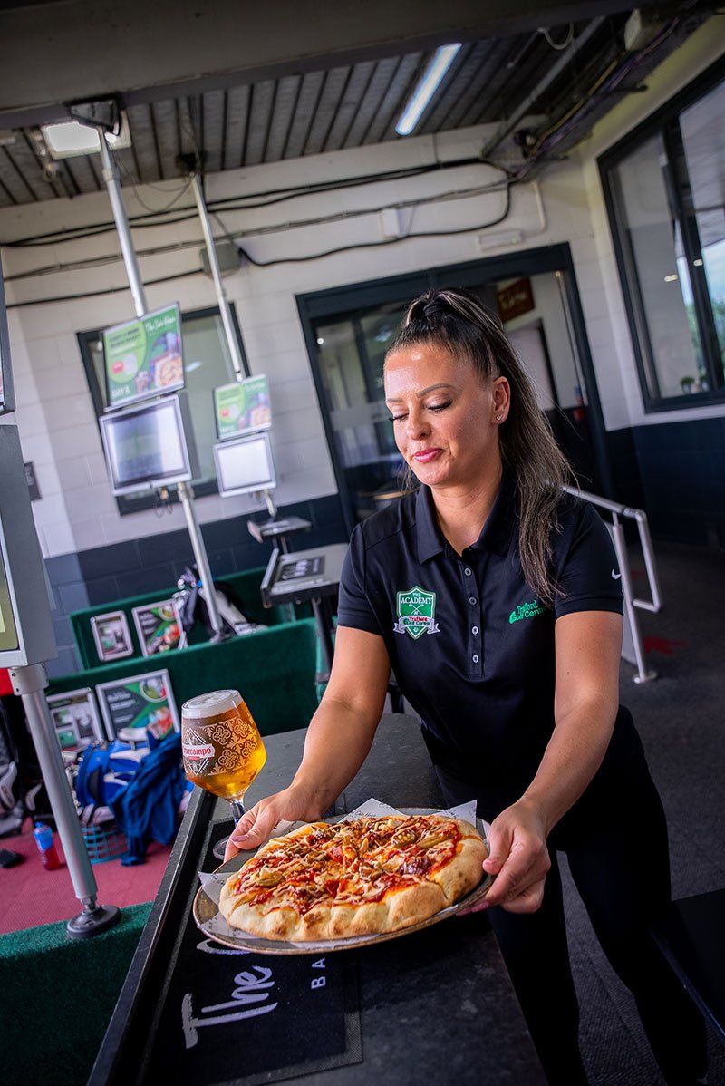 Girl serving food and drink at golf bay