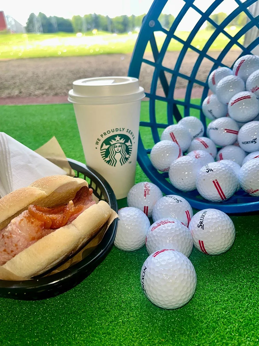 Basket of golf balls, bacon butty and a Starbucks drink
