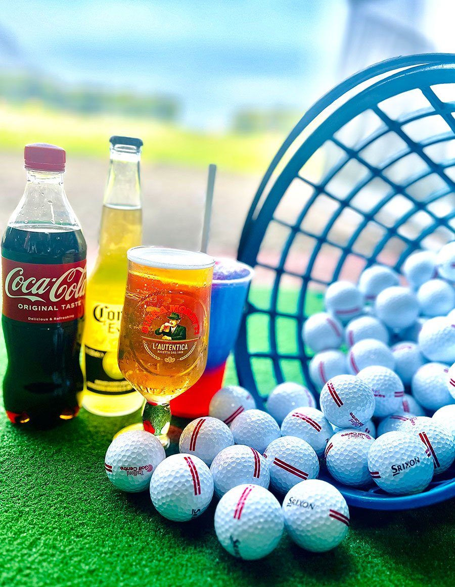 Basket of golf balls with a selection of drinks