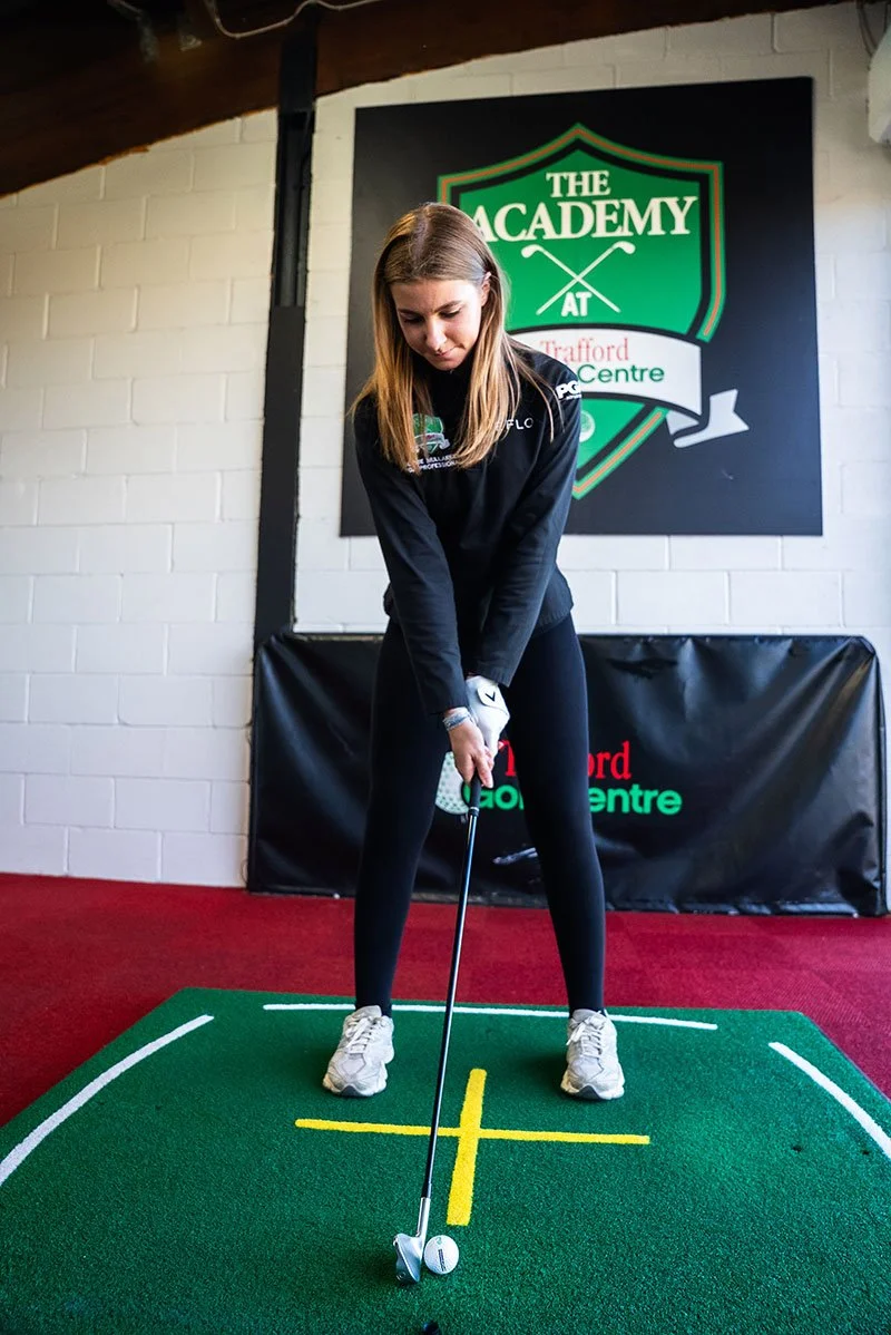 Girl about to hit a golf ball