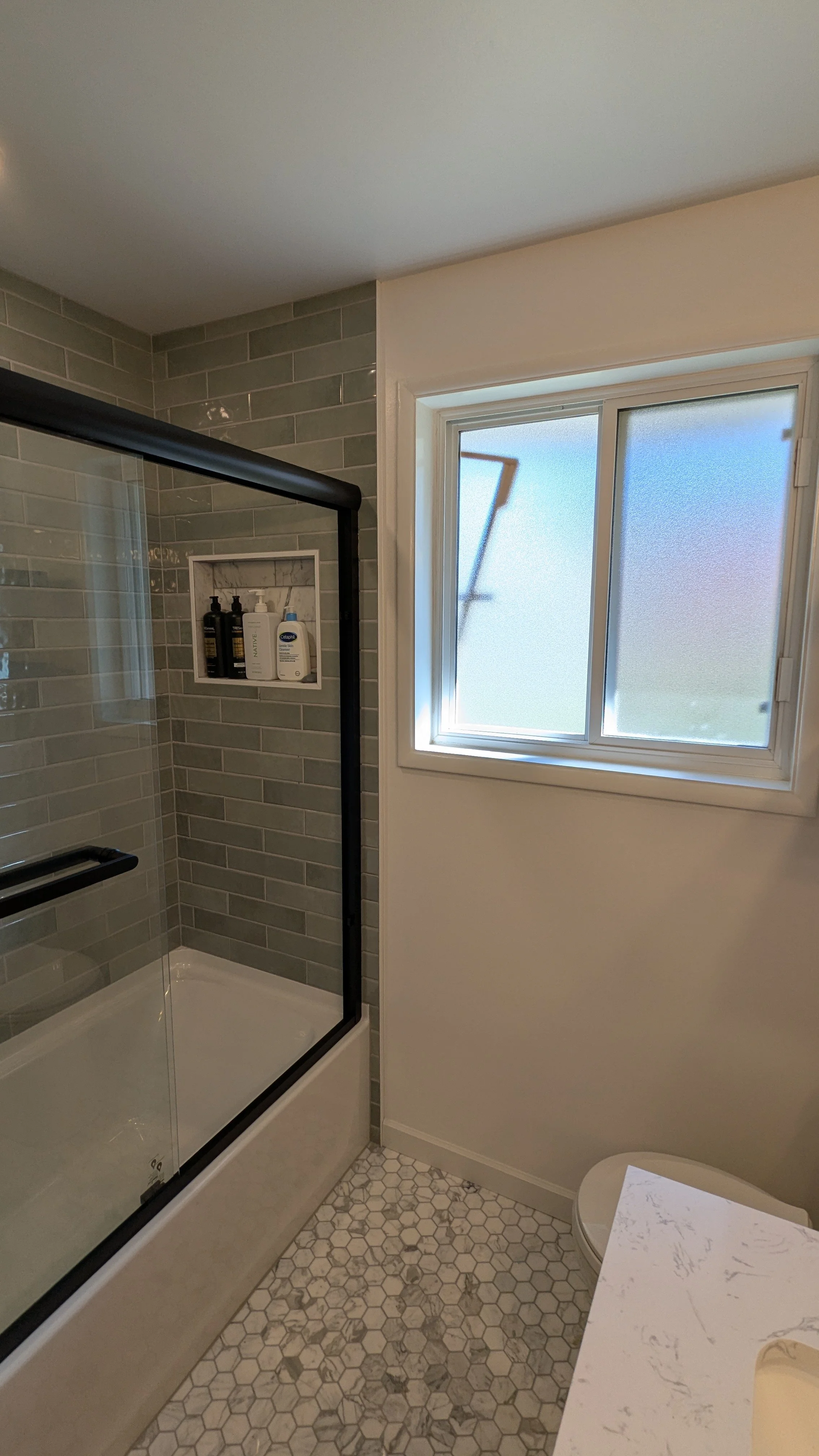 Opening up the window space brings in so much natural light in this Bellevue area bathroom remodel. 