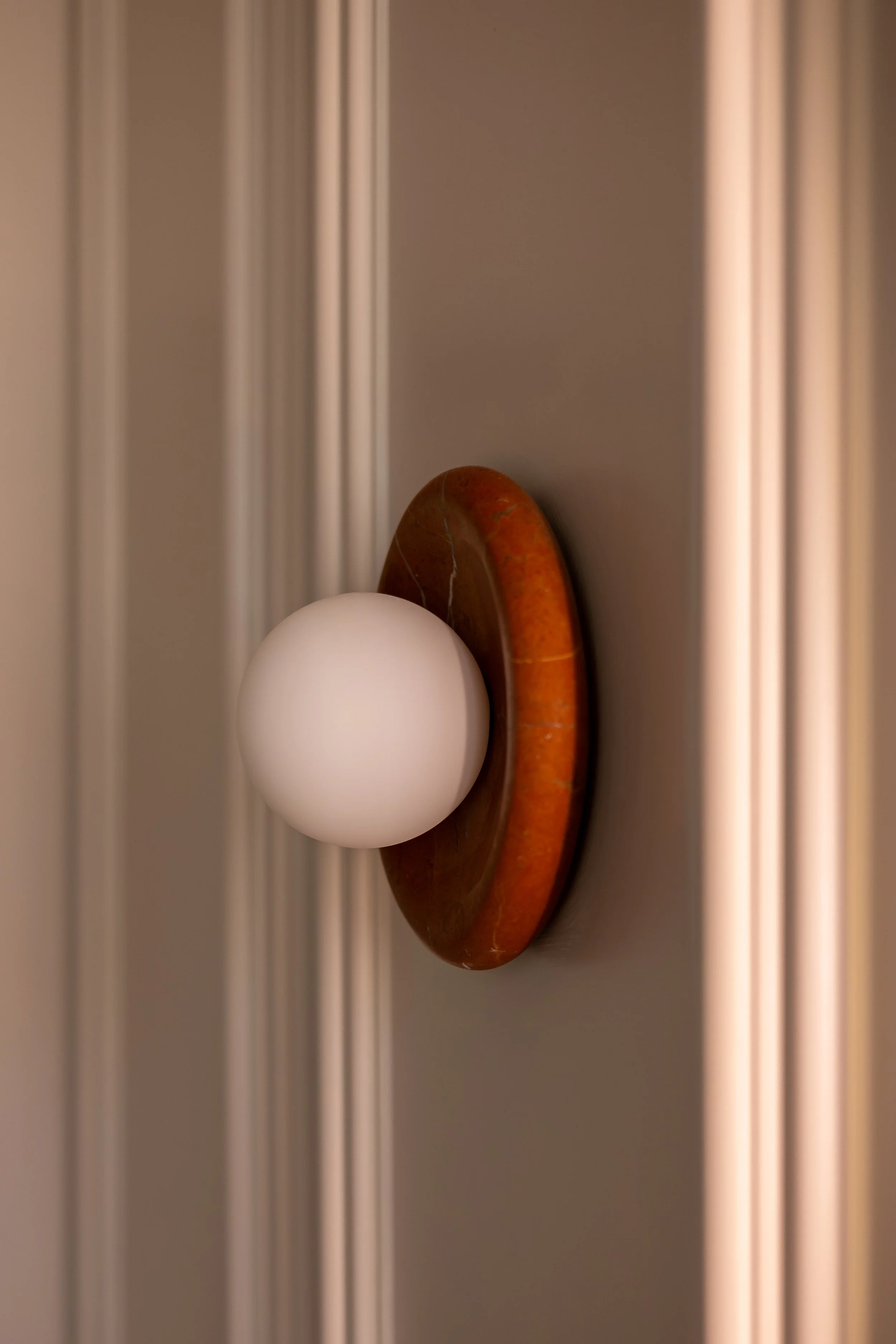 Interior design by oH Studio, red marble wall light