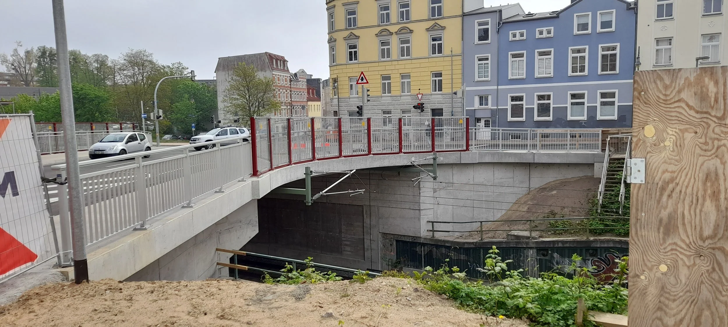 Bauoberleitung und Bauüberwachung Wallstraßenbrücke Schwerin: fertiggestellte Brückenrampe mit Geländer über Bahntrasse im innerstädtischen Umfeld.