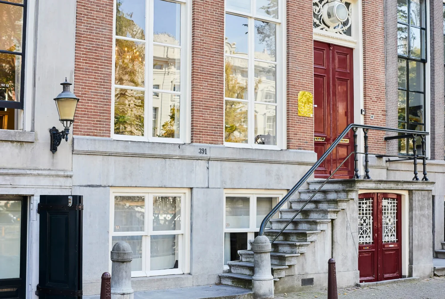 Mitochondria’s office in Amsterdam, a brick townhouse with large windows and a red front door