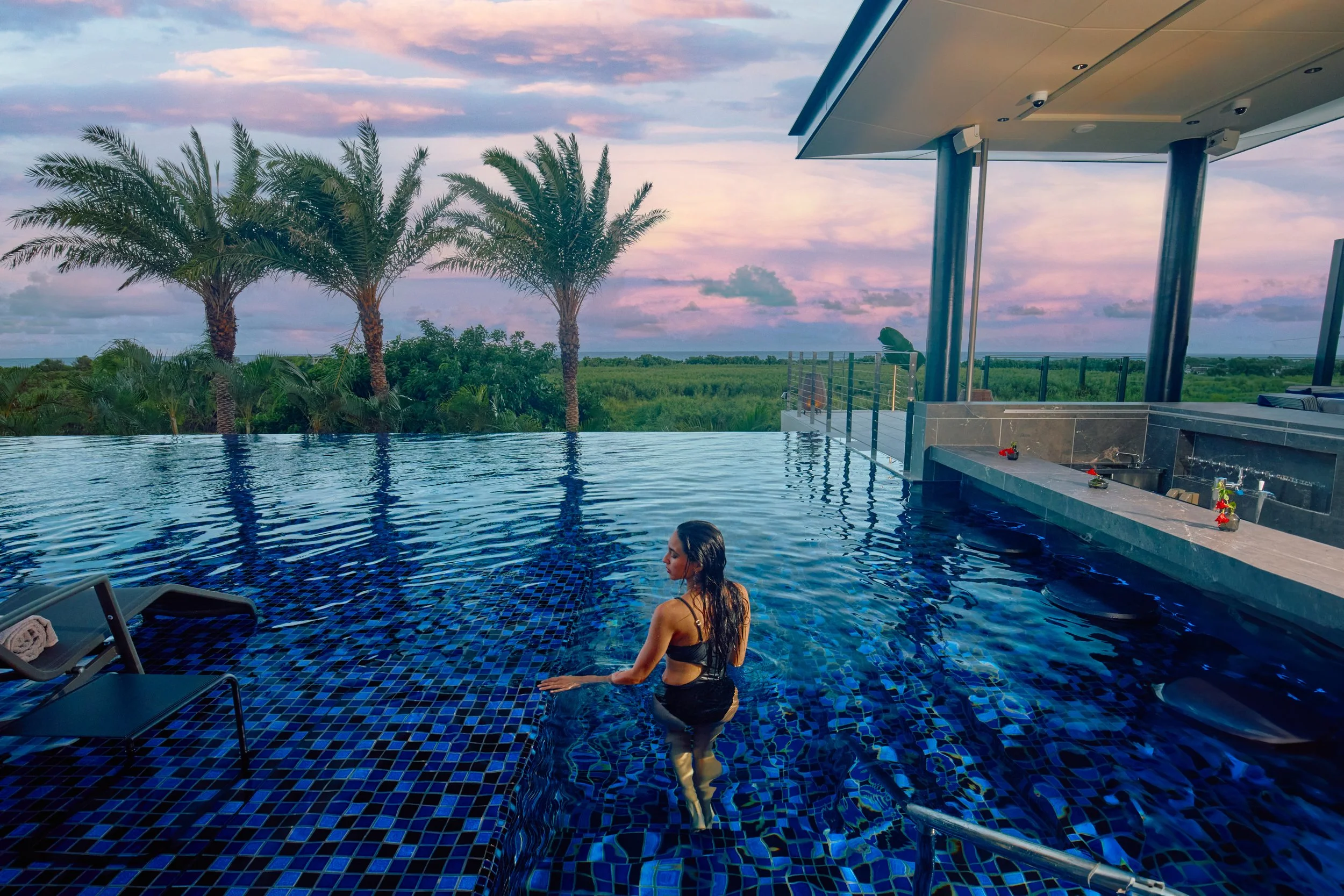 Outdoor hotel swimming pool with palm trees