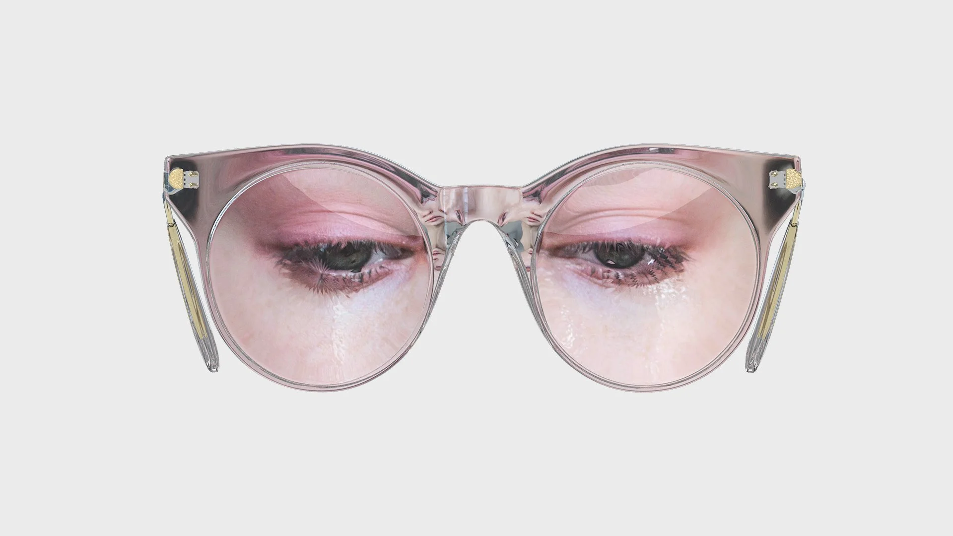 Pink-framed round glasses with a reflection of closed eyes and makeup.