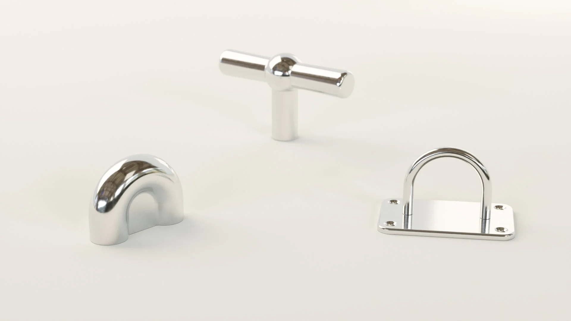 Three metallic hardware fittings on a white background: an arched handle on the left, a T-shaped handle in the center, and a U-shaped bracket on the right.
