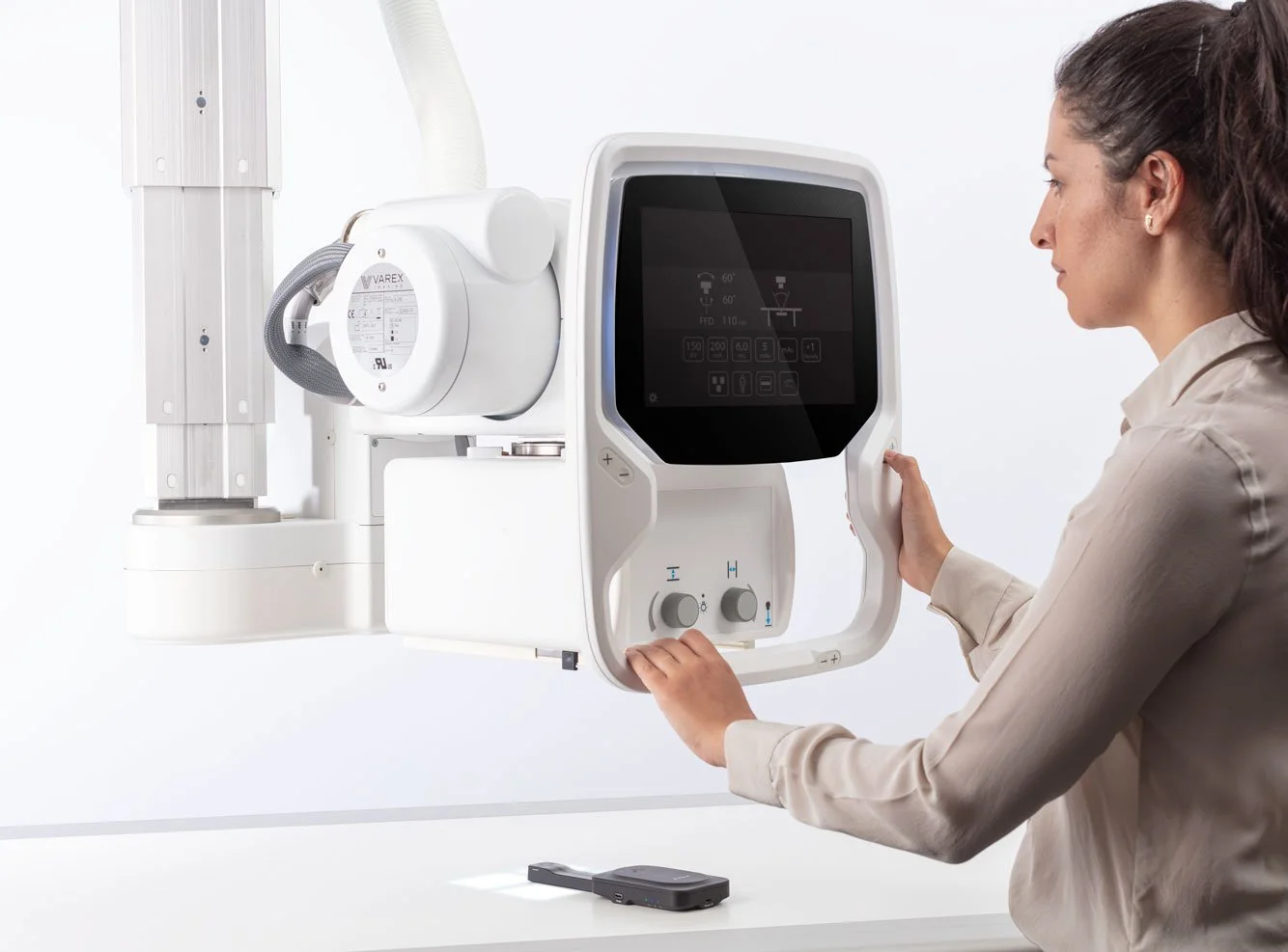 A woman operating a panoramic dental X-ray machine.