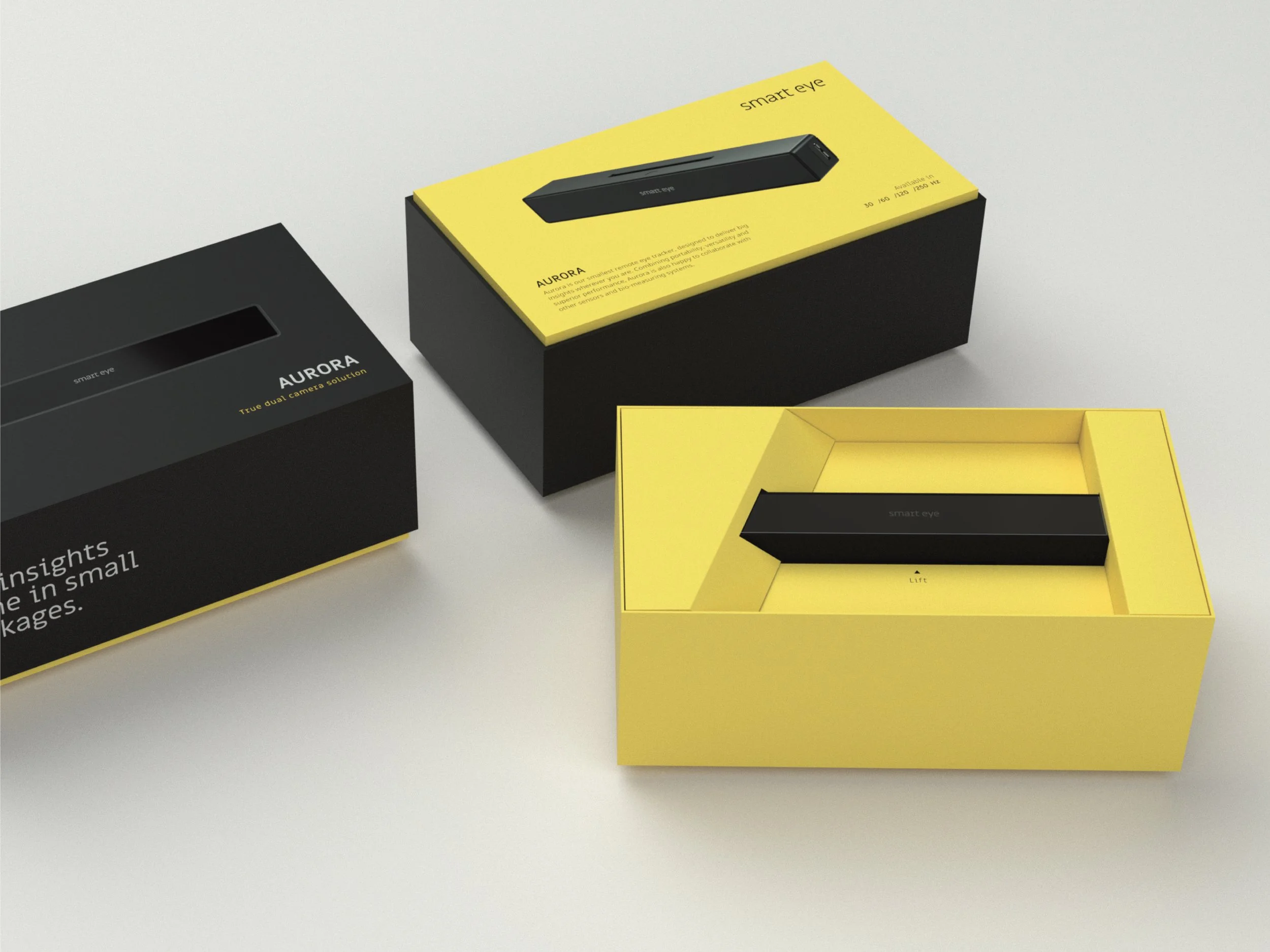 Three black and yellow product boxes on a white surface, with one open box revealing a black device inside.