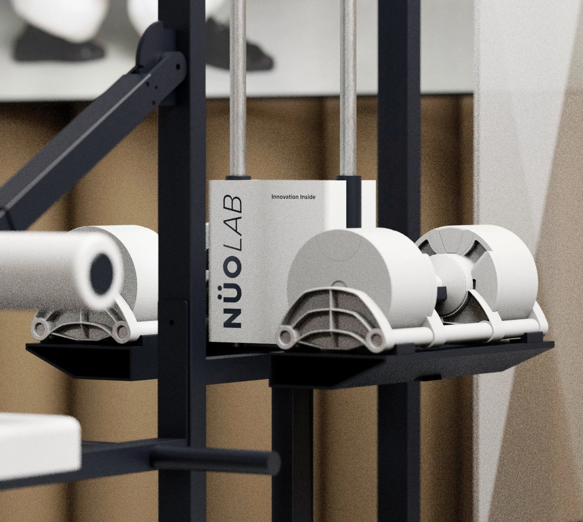 Close-up of a roll of white paper on a black stand, a white box labeled 'NÜJÖ LAB' with the words 'Innovation Inside,' and a black arm structure.