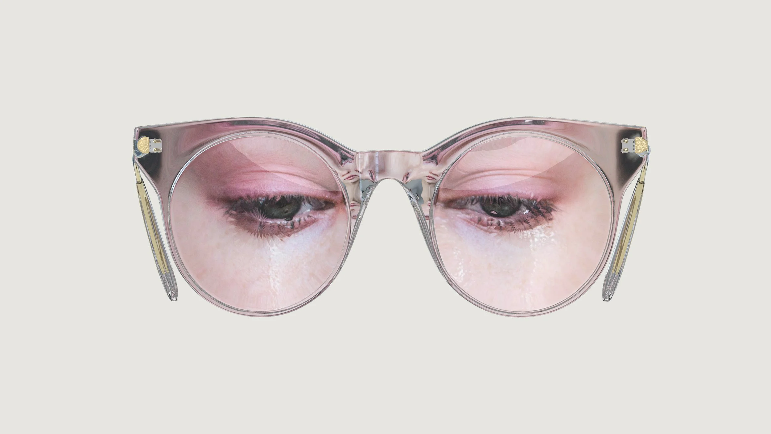 A pair of pink transparent sunglasses with a reflection of a person's eyes and eyelids in the lenses.