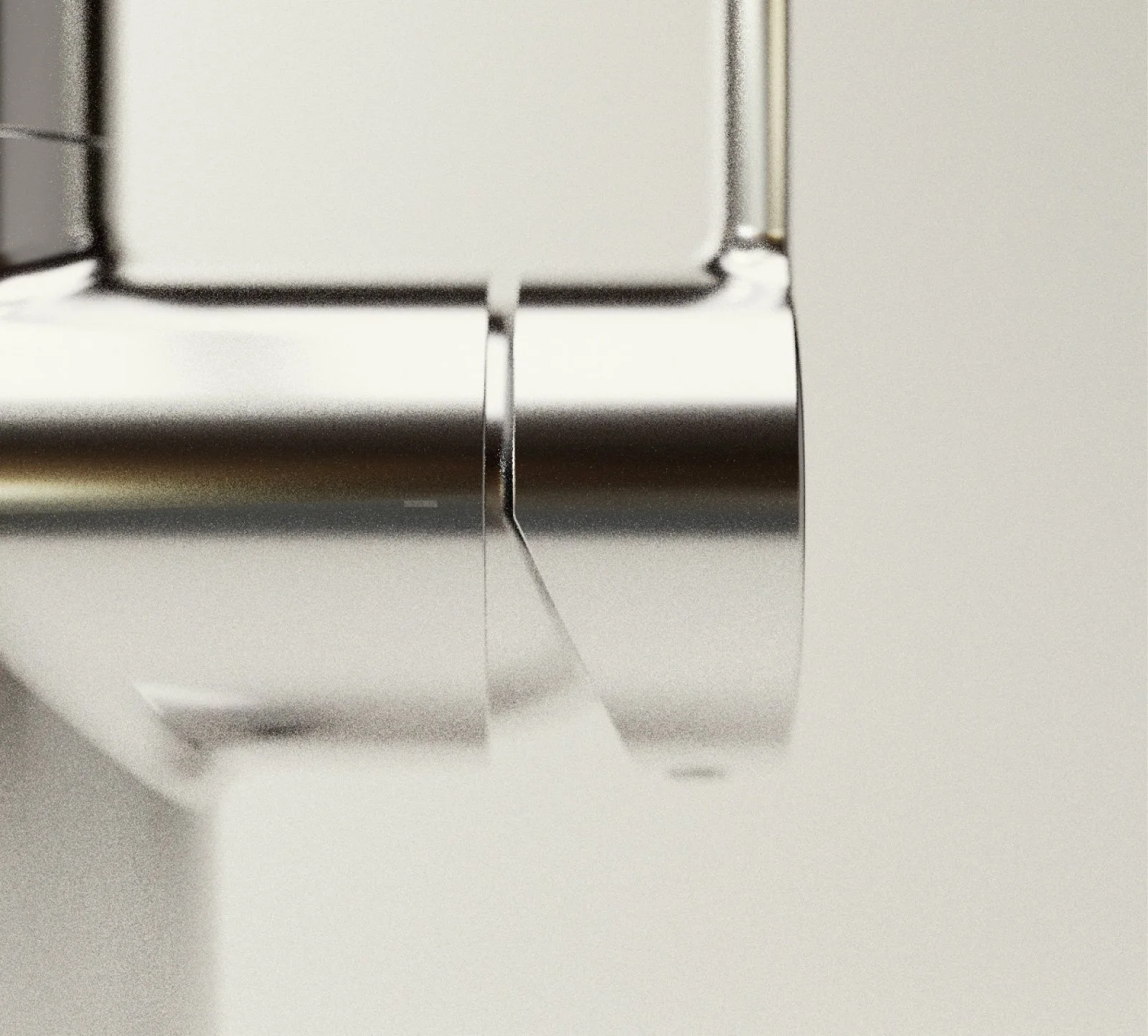 Close-up of a metallic object with a smooth, reflective surface and a curved edge, mounted on a light-colored background.